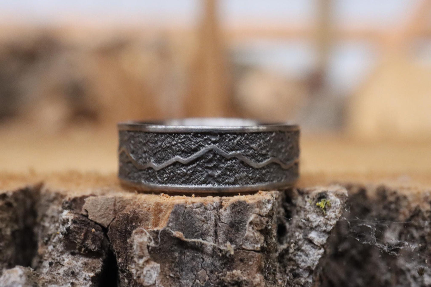 Handcrafted titanium ring with a rugged mountain range design, inspired by the Rockies. 'The Rocky Ridge' symbolizes strength and adventure, perfect for outdoor enthusiasts. A unique statement piece for those who love nature and the great outdoors.