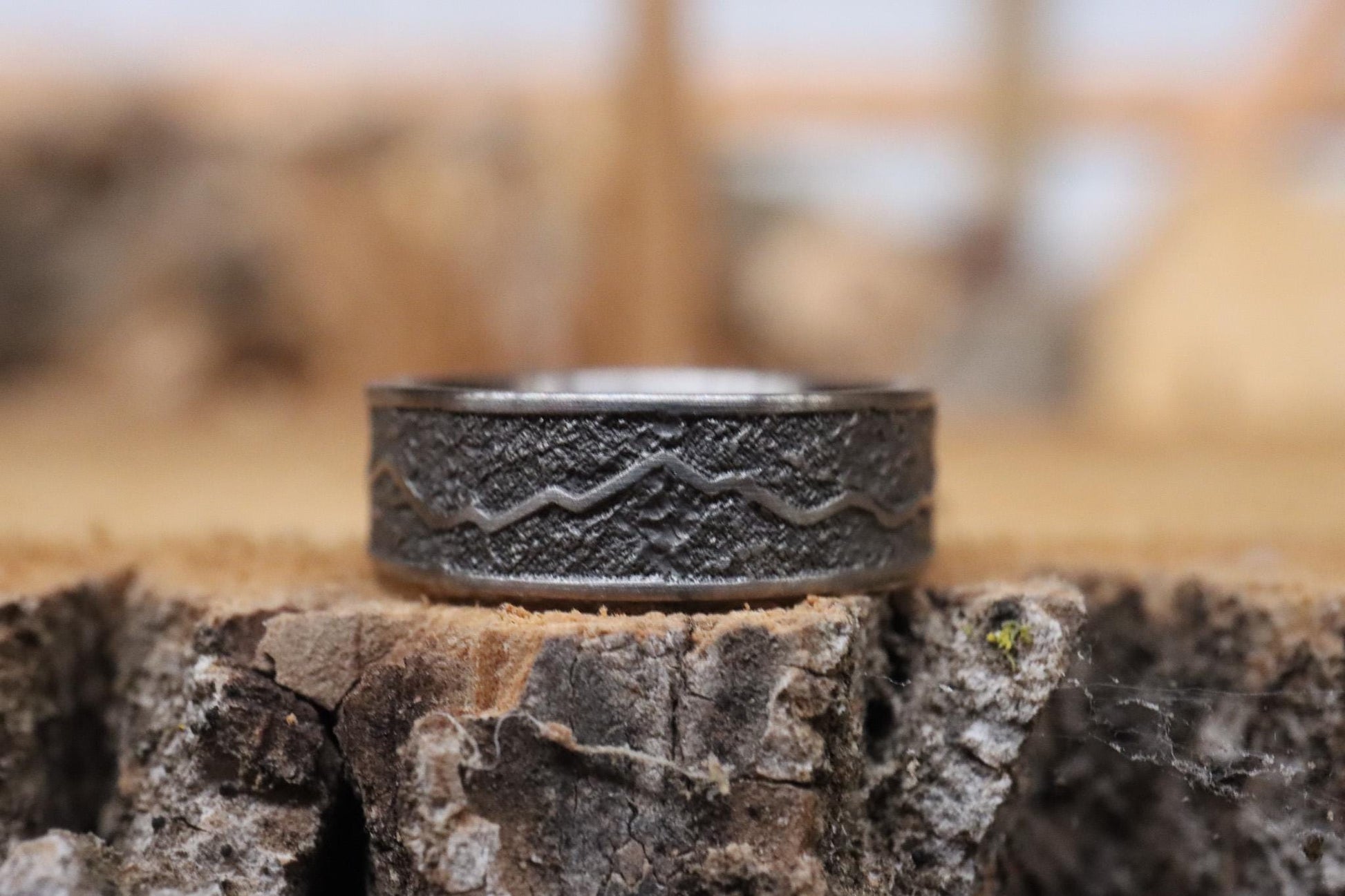 Handcrafted titanium ring with a rugged mountain range design, inspired by the Rockies. 'The Rocky Ridge' symbolizes strength and adventure, perfect for outdoor enthusiasts. A unique statement piece for those who love nature and the great outdoors.