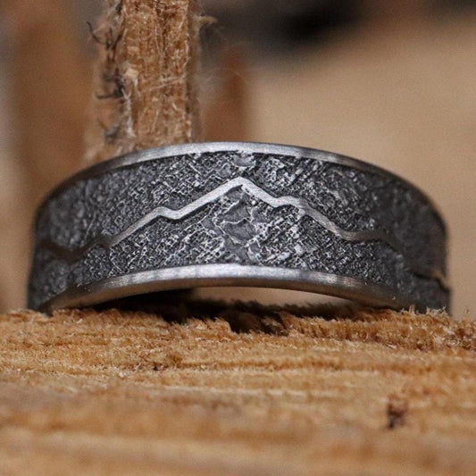 Handcrafted titanium ring with a rugged mountain range design, inspired by the Rockies. 'The Rocky Ridge' symbolizes strength and adventure, perfect for outdoor enthusiasts. A unique statement piece for those who love nature and the great outdoors.