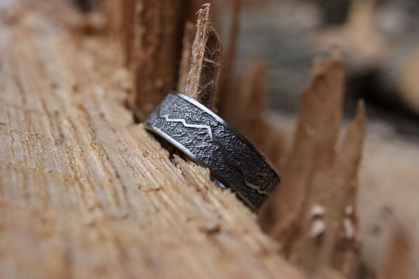 Handcrafted titanium ring with a rugged mountain range design, inspired by the Rockies. 'The Rocky Ridge' symbolizes strength and adventure, perfect for outdoor enthusiasts. A unique statement piece for those who love nature and the great outdoors.