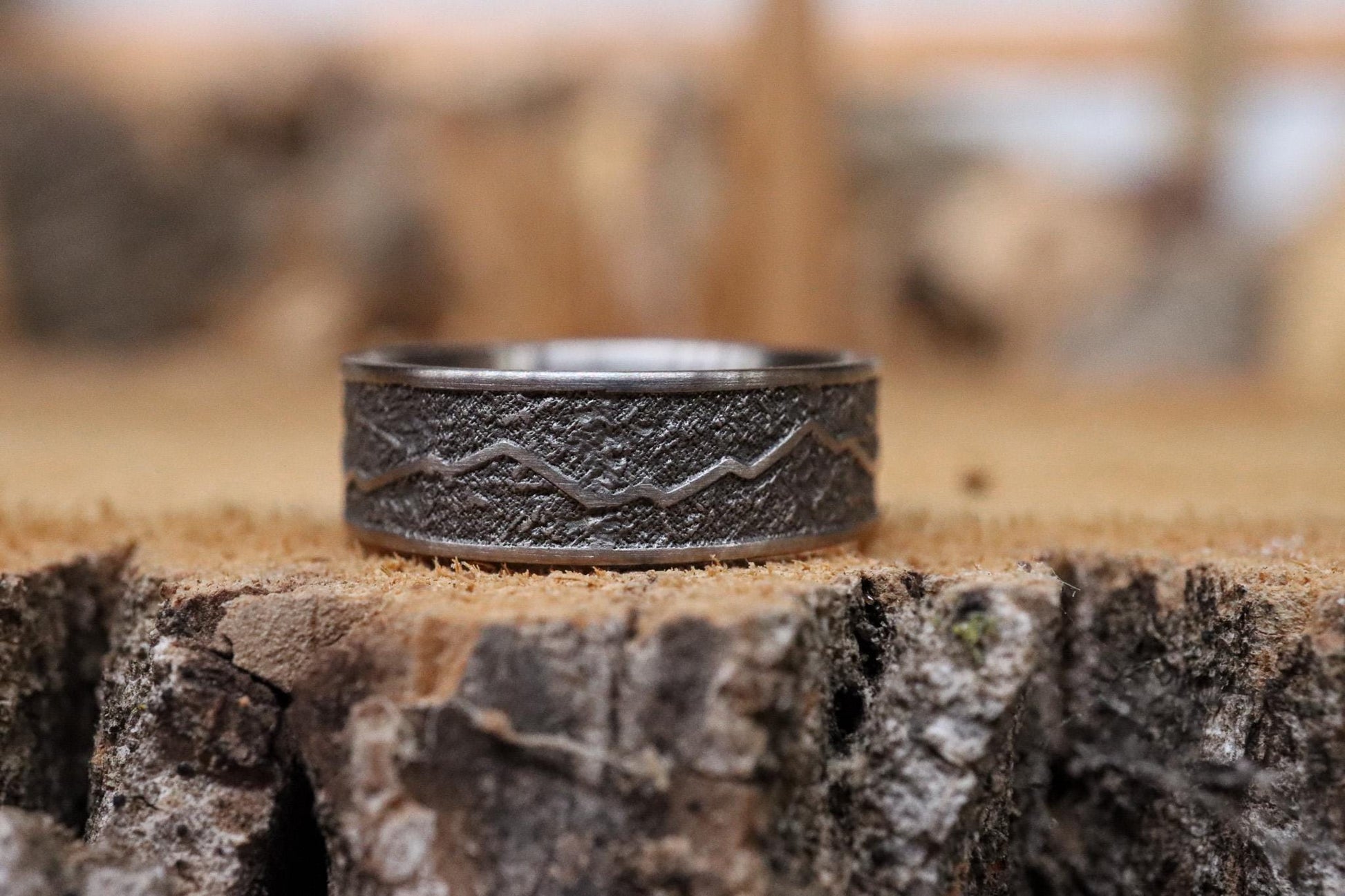 Handcrafted titanium ring with a rugged mountain range design, inspired by the Rockies. 'The Rocky Ridge' symbolizes strength and adventure, perfect for outdoor enthusiasts. A unique statement piece for those who love nature and the great outdoors.