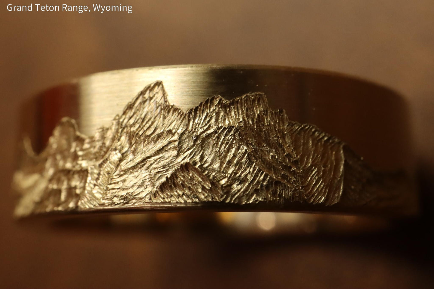 Grand teton mountain range, hand carved on to 14k Yellow gold ring. 6mm wide with comfort fit profile