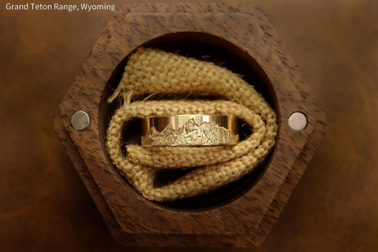 Grand teton mountain range, hand carved on to 14k Yellow gold ring. 6mm wide with comfort fit profile