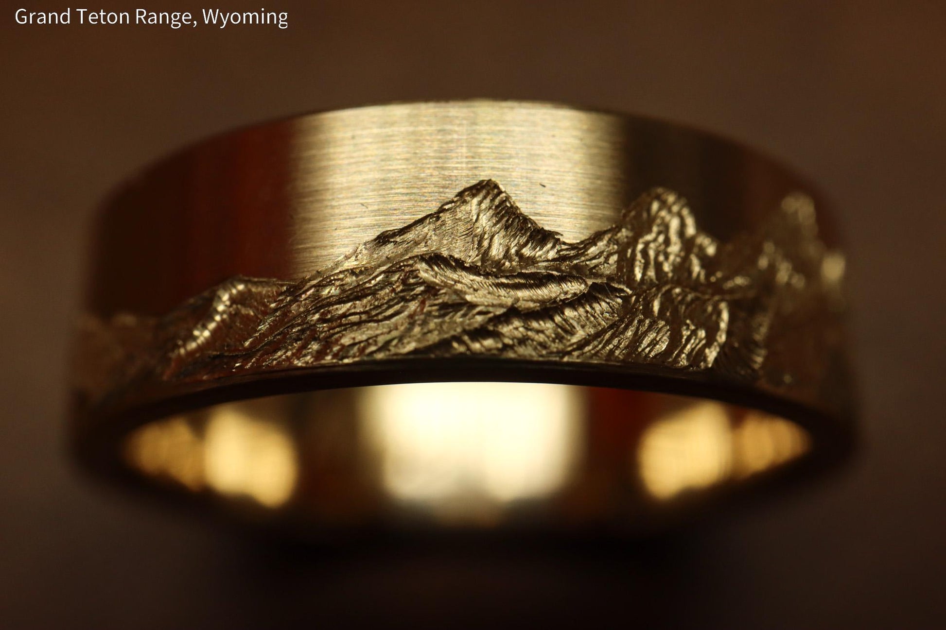 Grand teton mountain range, hand carved on to 14k Yellow gold ring. 6mm wide with comfort fit profile