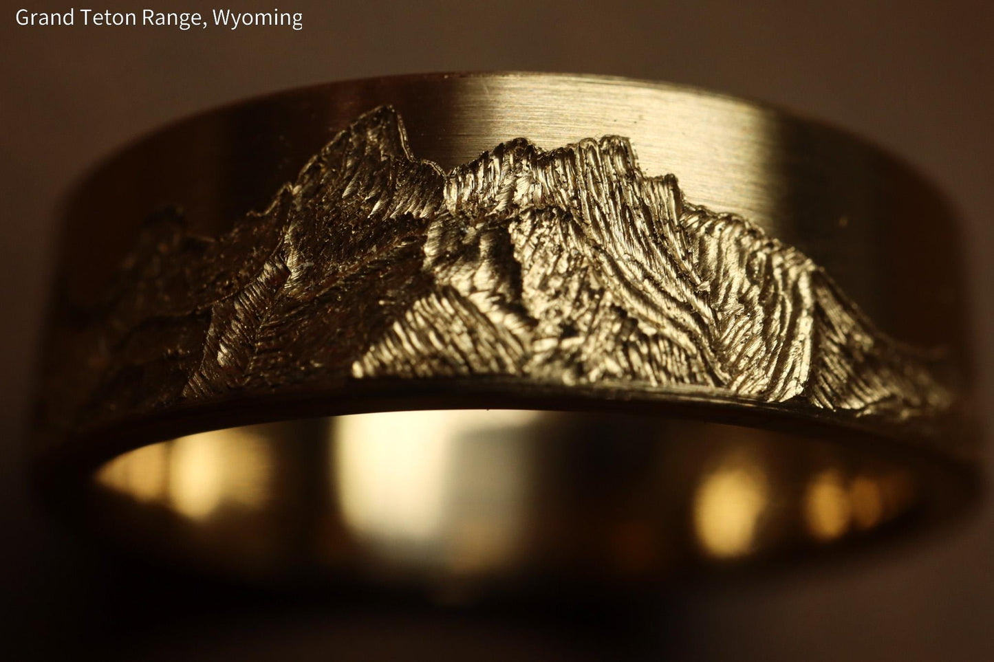 Grand teton mountain range, hand carved on to 14k Yellow gold ring. 6mm wide with comfort fit profile