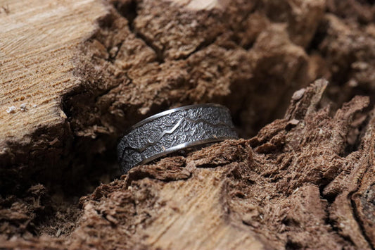 Handcrafted titanium ring with a rugged mountain range design, inspired by the Rockies. &#39;The Rocky Ridge&#39; symbolizes strength and adventure, perfect for outdoor enthusiasts. A unique statement piece for those who love nature and the great outdoors.